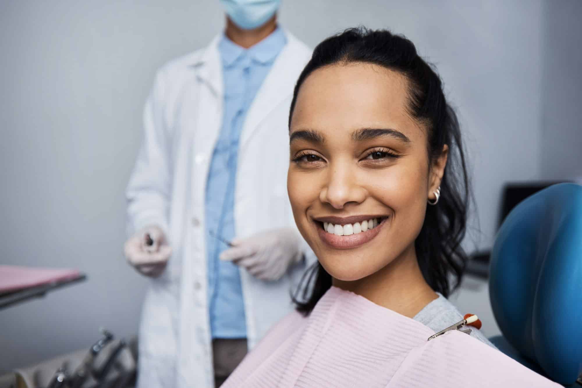 oung woman smiling during dental exam at Mayfair Family Dentistry, highlighting the importance of regular dental checkups for maintaining a healthy smile.